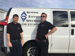 2 GES Employees in front of General Elevators Service Truck